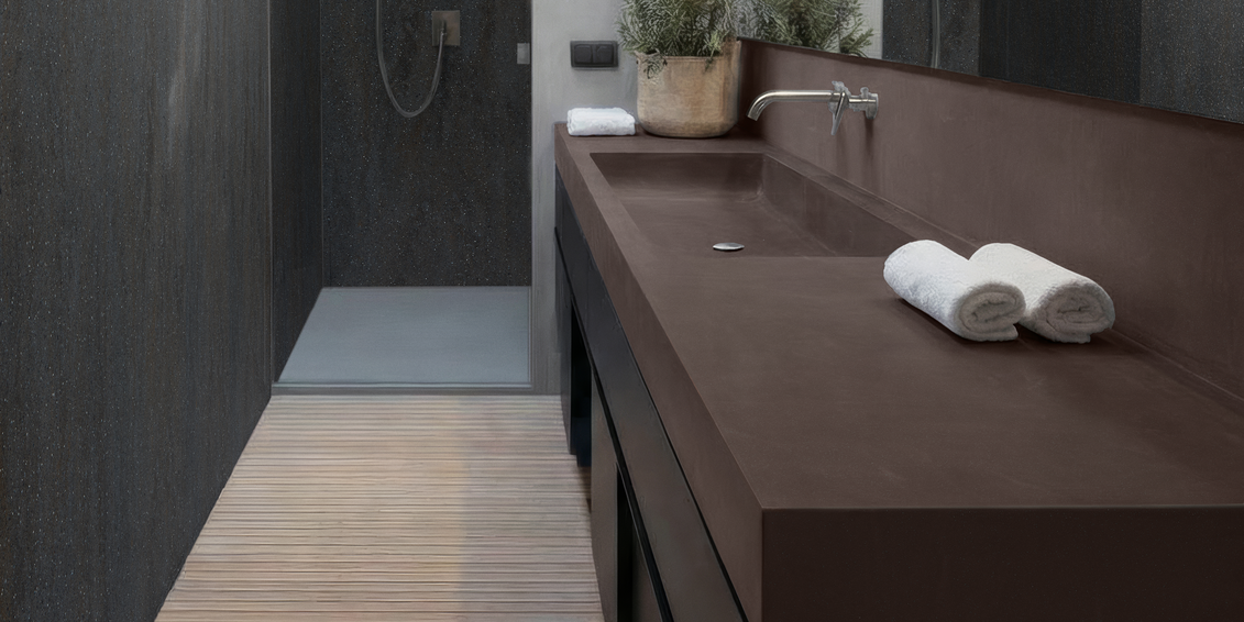 Moderner Waschtisch aus Corian® mit nahtloser Oberfläche, klarer Formensprache in einem puristisch gestalteten Badezimmer